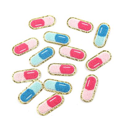 China Sew-on Iron-on Sticker Pink Glitter Patch Letter Pill Shape Iron On Patch Adhesive Chenille Towel Pin Embroidery Patches For Cosmetics Makeup Pouch Bag for sale