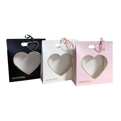 China Recycled Materials Cajas Emballages Carton Wholesale Water Proof Specialty Heart Folding Box Flower Gift Pakage Box Handle Paper Style for sale