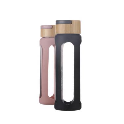 China Sustainable Frosted Glass Water Bottle With Silicone Sleeve for sale