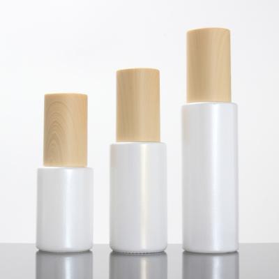 China 20ml 40ml 60m 80ml 100ml 120ml cosmetic white lotion pump glass bottle with bamboo lid for sale