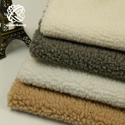 China 2021 New Auto Upholstery Wholesale Price Winter Coat 100% Polyester Sherpa Wool Fleece Faux Fur Fabric For Coat for sale