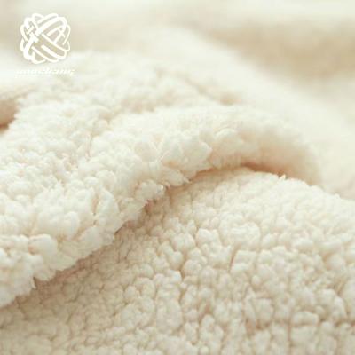 China Auto Upholstery High Quality Super Soft Sherpa Fleece Faux Fur White Black White Fabric For Garment Cover for sale