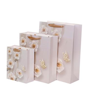 China Hottest Selling Paper Bag Recyclable With Flower Design Gift Paper Bag Luxury Shopping Bag For Clothing for sale