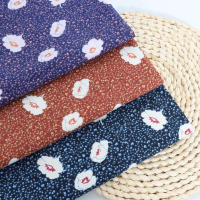 China Non-conductive the latest fashion printed flannel fabric cheap and high quality soft fabric dark colors clothing is women's style for sale