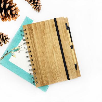 China Custom logo spiral cover spiral journal wooden a5 bamboo notebook with ballpoint pen for sale