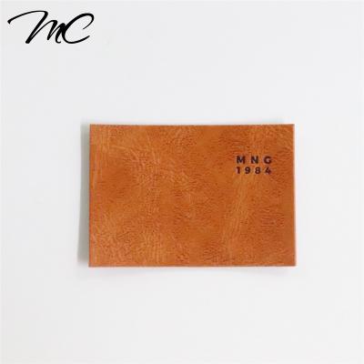 China Viable Custom PU Labels Hot Selling Brand Logo Leather Patches Labels For Clothing And Bags for sale