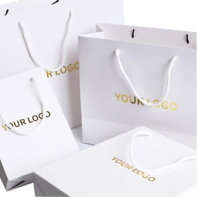 China Biodegradable Custom Shopping Bags For Clothing Gold Printed Logo Design White Cardboard Paper Packaging Bags For Retail for sale