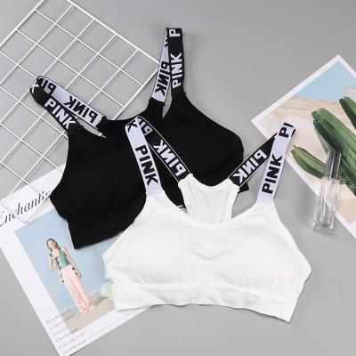 China Custom Letter Cotton One Piece Radio Sports Fitness Tops Invest Cross Straps Bralette Womens Ladies Backless Bra For Girls for sale