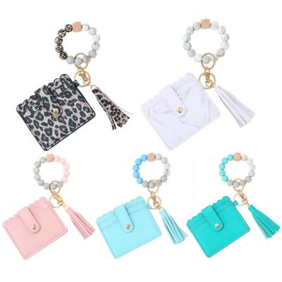 China 2021 Wholesale Religious Silicone Bead Key Chains Pinch Key Chain Tassel Leather Bag Key Chain For Credit Card Bags Wallet Bangle Bracelet for sale