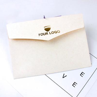 China Materials that respect the environment. Non-toxic Customized Black Logo Hot Stamping White Paper Envelope Packaging With Ribbon for sale