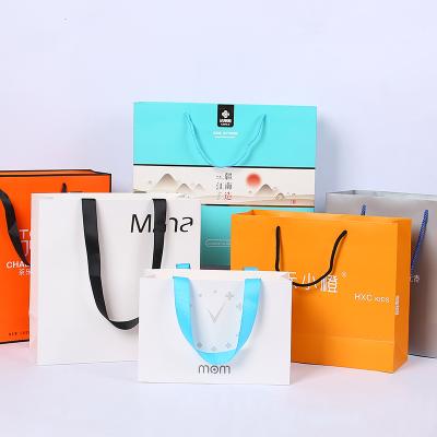 China Recycled Materials Recycled Custom Cardboard Luxury Gift Paper Bags With Handle Retail Clothing Packaging Paper Bag With Your Own Logo for sale