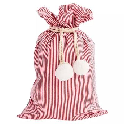 China Red Striped Pom Pom Canvas Christmas Santa Sack White Christmas Daily Decoration Drawstring Gift Bag for sale