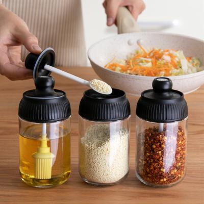 China Viable Bpa Free Clear Salt Bottles Glass Shaker Bottle Jam Spice Jar Seasoning Container With Spoon Brush for sale