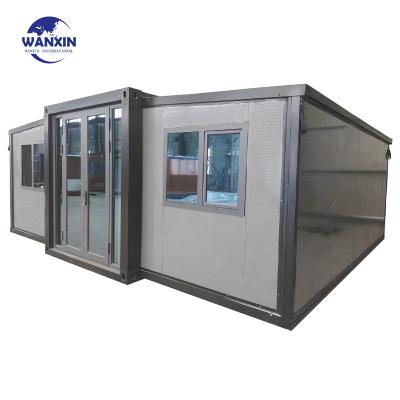 China Modern Cheap 30m2 323sqf Prefab Flat Expandable Butterfly Container House Without Bathroom Kitchen for sale