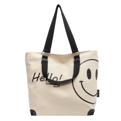 China Simple Smiling Canvas Large Tote Bag Fashion Face Pattern Swapping To Work Travel Shoulder Bag for sale