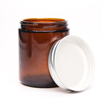 China Homemade Custom Wholesale 4oz 8oz 16oz Logo Round Amber Glass Candle Decoration Jar With Metal Screw Lid for sale