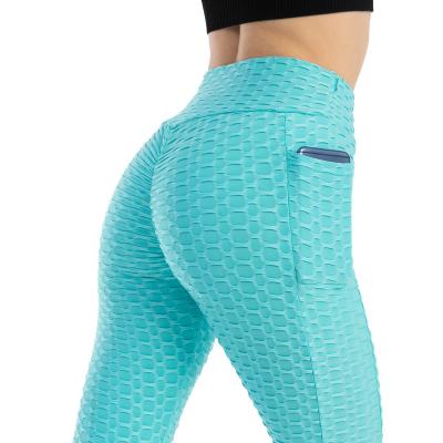 China Breathable Premium Pocket Waffle Pants Women Yoga Gaiters High Waist Yoga Pants Tummy Control for sale