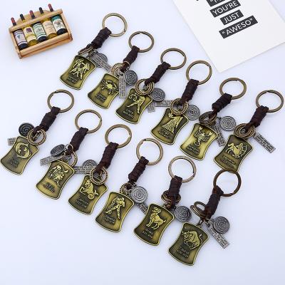 China Promotion Gift Sshui Retro Guitar Shaped Cowhide Metal Key Ring Zodiac Keychains For Birthday Woven Key Chain Handmade Gifts for sale