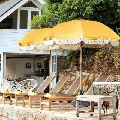 China Outdoor Modern Wooden Pole Canvas Waterproof Logo Patio Pool Sun Umbrellas Garden Free Beach Umbrella With Tassels for sale