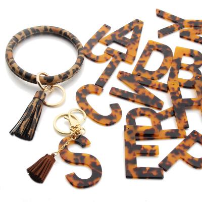 China NEW 26 English Initial Leather Tassel Key Chain Bracelet PU Leopard Key Chain Bracelet Birthday Letters Acrylic Charms for sale