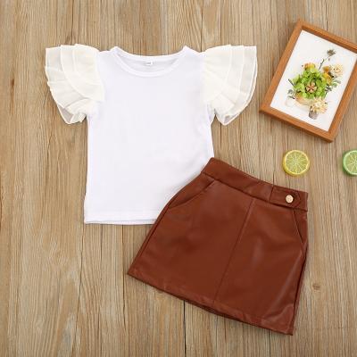 China 2021 Breathable Fashion 2Pcs Toddler Kids Baby Summer Clothes Sets White Short Sleeve Tops PU Leather Skirts Teams 1-6Y for sale