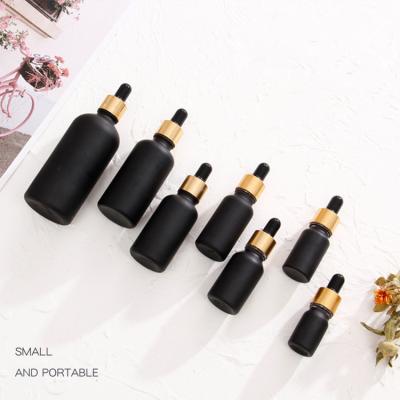 China Eco-friendly Recyclable Delicate Black Oblique Shoulder Essential Oil Glass Bottle With Dropper For Cosmetics Containers And Packaging for sale