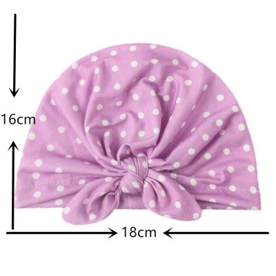 China New COMMON children's rabbit ears hat baby solid color polka dot India knotted hat baby turban hat for sale