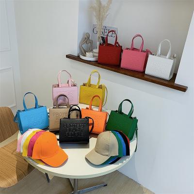 China 2023 Small Capacity Handbags Famous Brands Color Women Tote Bag One Shoulder Protect Designer Motion Sensing Mini Pu Purses Luxury for sale