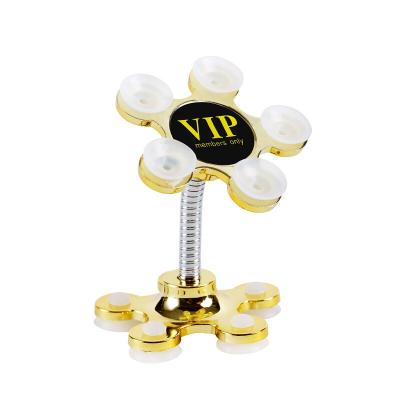 China Adjustable Sucker Stand for Cell Phone 360 degree Rotatable Metal Flower Magic Suction Cup Mobile Phone Holder Car Bracket for sale