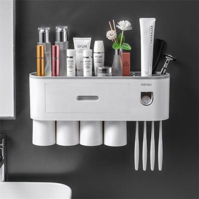 China Bathroom Accessories Durable Plastic Magnetic Automatic Wall Mount Toothpaste Dispenser Toothbrush Holder With Four Washing Cups for sale