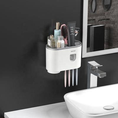 China 2021 New Arrival Bath Shelf Viable Storage Plastic Toothbrush Holder And Automatic Toothpaste Dispenser for sale