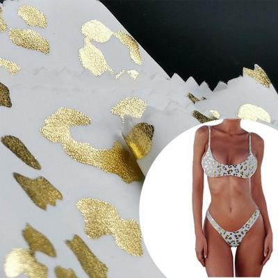 China Popular Designer 200gsm Gold Foil Gold Leopard Sequin Foil Print On Nylon Spandex Swimwear Fabric 82 18 for sale