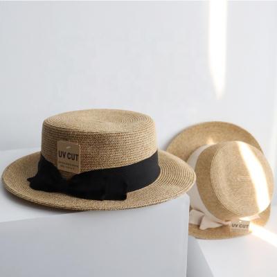 China Casual Bowknot Female Straw Cap Sun Shade Hat Madame Brand Women Flat Brim Panama Hat Summer Image 2022 Simple Beach Hat for sale