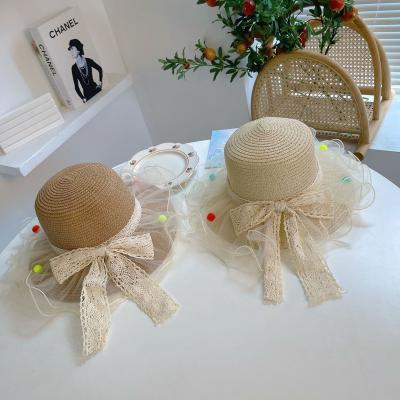 China New Sunscreen Children's Straw Sunshade Sunshade Sunscreen Hat Lace Bow Beach Hat With Bag for sale