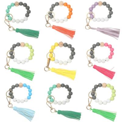 China Colorful Holder Key Chain Wood Beads Bracelet Key Chain For Women Color Leather Wooden Bracelet Candy Tassel Keychain Bead PU Tassel Key Chain for sale