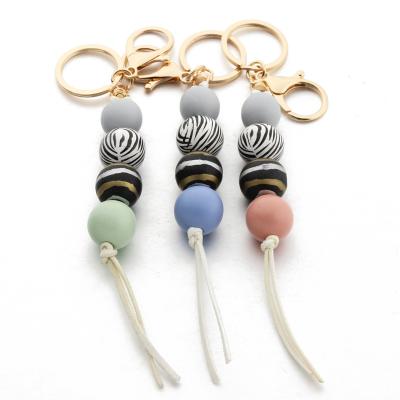 China New Fashion Souvenir Gifts Fashional Star Anise Wooden Bead DIY Key Chain Beaded Key Chain for sale