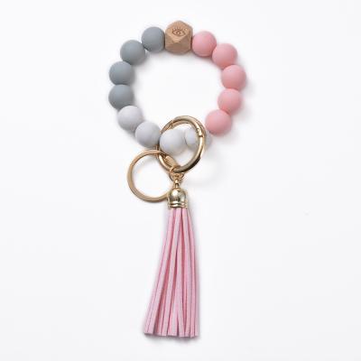 China New Fashion Souvenir Gifts Fashional Silicone Ladies PU Wood Leather Tassel Key Chain Bead Bracelet Pendant Key Ring for sale