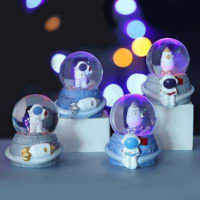 China 2023 Folk Art Astronaut Crystal Ball Resin Alien Ornaments With Lights And Drift Snow Hotel Home Decor Souvenirs Children Gifts for sale