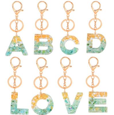 China Hot Sale Plastic A-Z Charm Letter Green Color Gold Leaf Amazon Alphabet Resin Key Chain Initial Gold/Silver Key Chain for sale