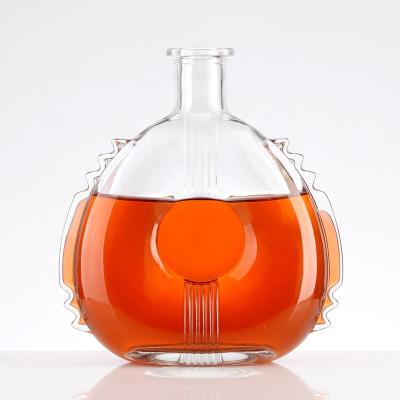 China Unique Design Liquor Design Transparent Flat XO Exquisite Embossed Pectoral Fin Consecrated Glass Bottle for sale