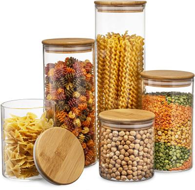 China Household Glass Heatable Storage Jars Transparent Bottle Glass Kitchen Canisters With Airtight Bamboo Lid for sale