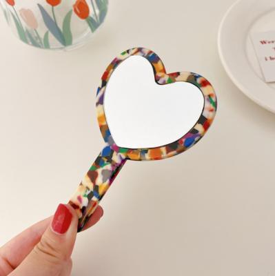 China Personalized environmental heart-shaped hand-held cosmetic hand mirror acetic acid mirror material makeup mirror for sale