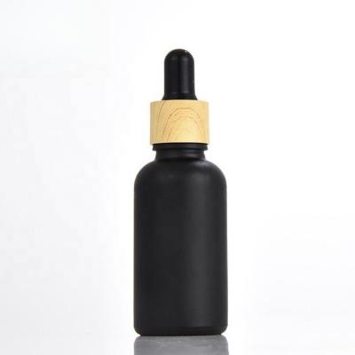 China Wishing matt black glass bamboo bottles 15ml 20ml 30ml 50ml 100ml glass essential oil bottles with bamboo cap dropper for sale