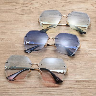 China Fashion sunglasses women irregular cut shape sunglasses personality pearl temples tide rimless sunglasses for sale