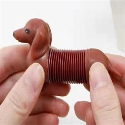 China Popular Amazon Trigger Spring Buster Dog Toys Flexible Stretch Toy Mini Pop Tube Spring Dog for Kids for sale