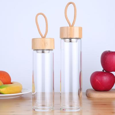 China Sustainable Sports Glass Bottle With Bamboo Lid And Portable Outer Cord Glass Bottles BPA Free for sale