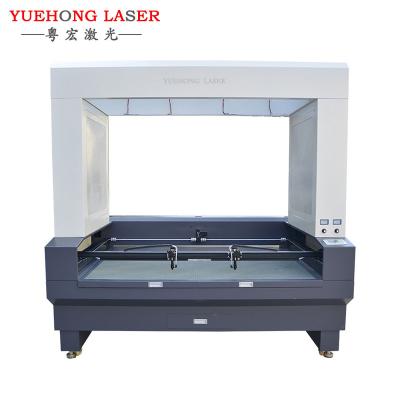 China Top Sale YH1810 1812 100w 120W 130w Laser Cutter Auto Feed Fabric Laser Cutting Machine For Trademark Garment Industry for sale