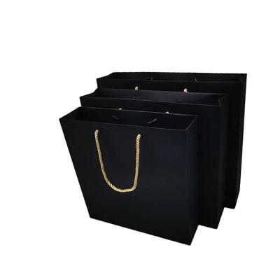 China Gift & Hot Selling Customized Craft Logo Black Kraft Paper Bag With Handle for sale