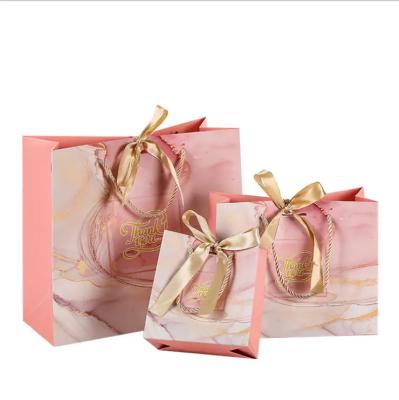 China Wholesale disposable handle packaging gift custom printed jewelry shopping paper bag with bow knot ribion for sale