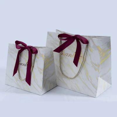 China Luxury Cute Disposable Ribbon Bow Cosmetics Packaging Gift Paper Bag For Custom Cosmetics Ribbon Gift Bag With Logo Paper for sale